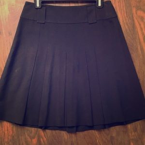 Knee length pleated black skirt